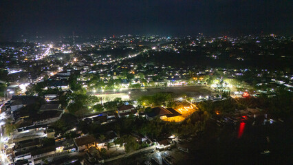 The atmosphere of Waingapu's Old Town to the Seaport seen from the air with a drone at night