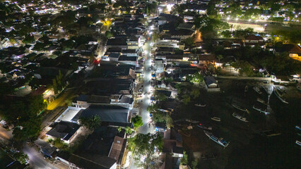The atmosphere of Waingapu's Old Town to the Seaport seen from the air with a drone at night