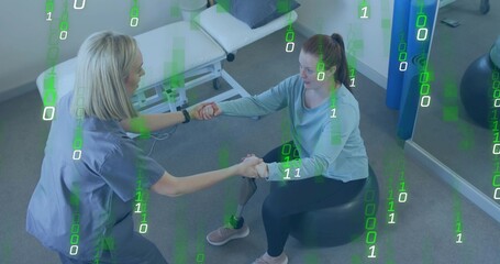 Balancing therapist and patient in rehab clinic, with stability ball, foam rollers, prosthetic leg