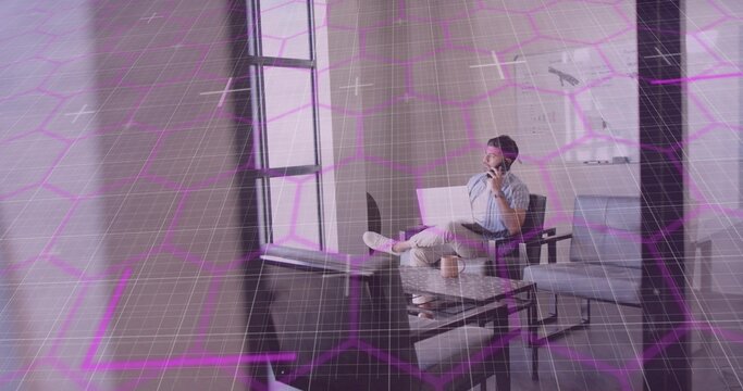 Remote worker holding smartphone to ear and balancing laptop in home lounge, coffee mug, copy space