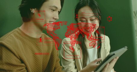 IT colleagues examining tablet screen in office with red map overlay and SYSTEM HACKED alert