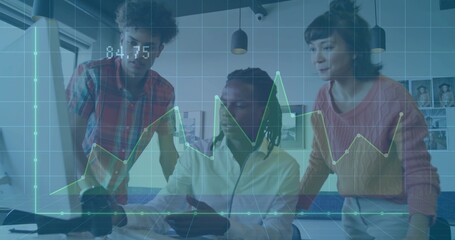 Colleagues reviewing data trends in modern office at desk, with laptop, monitor and graph overlay