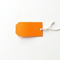 Orange price tag with string rests on white surface. Blank label ready for custom text. Simple object for retail sale or product pricing. Minimal design element.