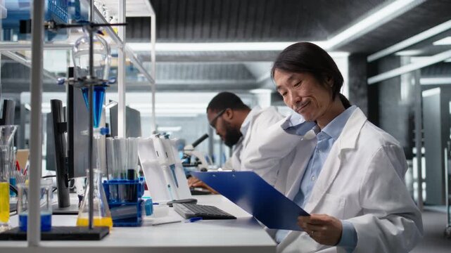 Senior laboratory scientist feeling neck ache while using computer to log patient data clinical. Lab professional pained by incorrect posture at PC, looking at genetic analysis documents, camera A
