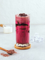 Iced Red Velvet Chocolate Drink in a Glass with Cocoa Powder – Refreshing Creamy Beverage on Light Background– Sweet Summer Drink