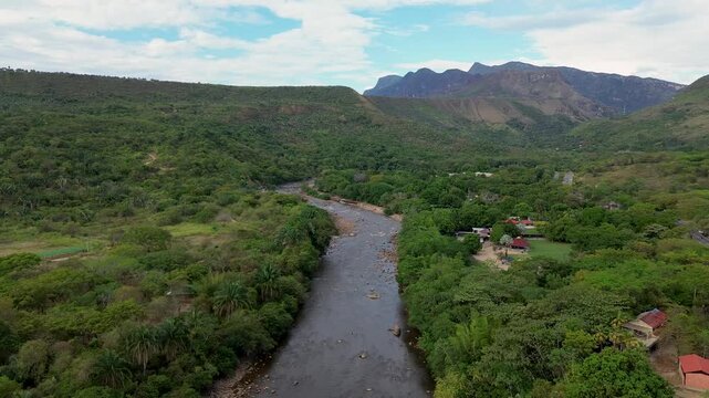 Aerial view of a large tropical river, Flowing water surrounded by lush vegetation, Sumapaz River in Tolemaida Colombia. High quality 4k footage