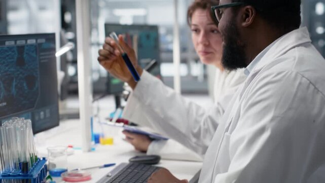Team of lab technicians using chemical solutions, creating mixtures for scientific study, doing purity verification. Laboratory workers brainstorming, doing RD with solutions, camera B