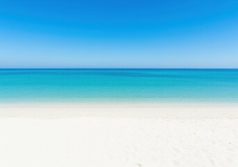 Obraz premium Pristine white sand beach meeting calm turquoise ocean water under a clear blue sky.