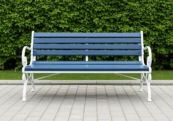 Empty blue wooden park bench with white metal frame against a lush green hedge wall.