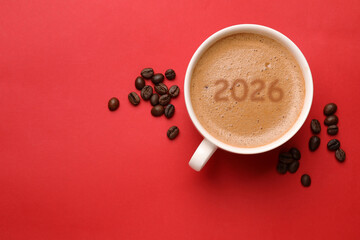 Hello New 2026 Year. Cup of coffee with numbers and roasted beans on red background, top view