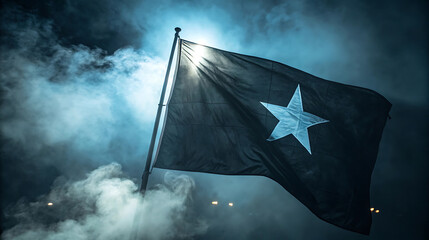 Waving black flag with a white star against a smoky dark sky