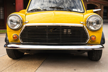 Vintage Yellow Compact Car – Classic Front View
Close-up of a vintage yellow compact car with chrome details and round headlights, symbolizing retro design, style, and nostalgia.