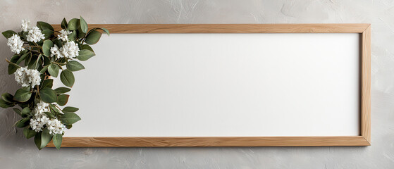 Wood frame whiteboard with floral accent and green leaves on textured wall, minimalist horizontal blank sign for message or mockup, soft natural lighting and neutral decor