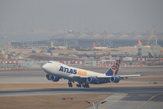 Hong Kong China - 2018 January 23: An Atlas Air Boeing 747-8F cargo aircraft (registration N855GT) climbs after taking off from Hong Kong International Airport (HKG).