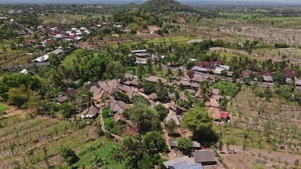 Aerial drone view of Sade traditional village in Lombok, Indonesia — authentic Sasak culture and thatched-roof houses surrounded by tropical landscape