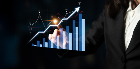 A business professional examines a digital growth chart that symbolizes success and strategic...