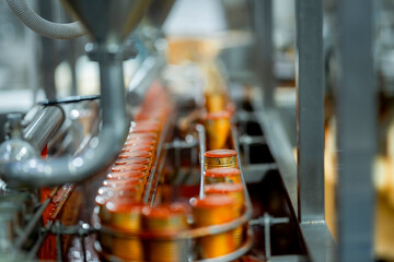 Canning process in a food production facility showing cans being filled and sealed Emphasis on automation cleanliness and manufacturing efficiency.