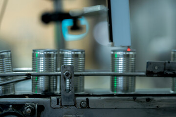 Canning process in a food production facility showing cans being filled and sealed Emphasis on automation cleanliness and manufacturing efficiency.