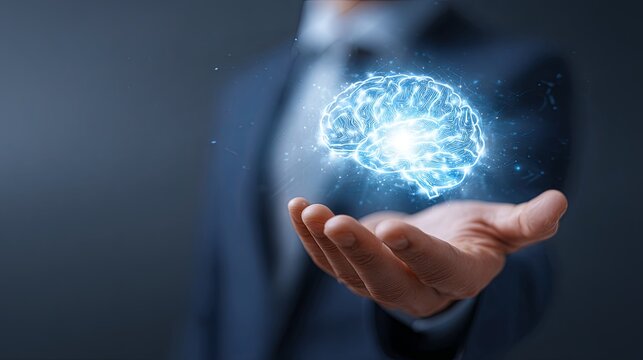 Businessman presents glowing holographic human brain model hovering above open palm