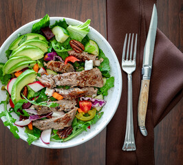 Top down view of a delicious homemade steak salad, ready for eating.