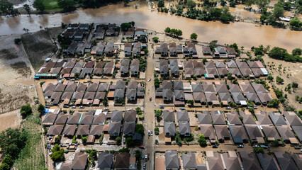 Aerial view of housing estate in suburb of Chiang Rai province flooded by Kok river rising after heavy rain. Chiang Rai hit by flash floods and runoff after overnight rain.