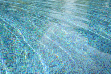 Swimming pool with blue crystal clear water surface and ripple wave background