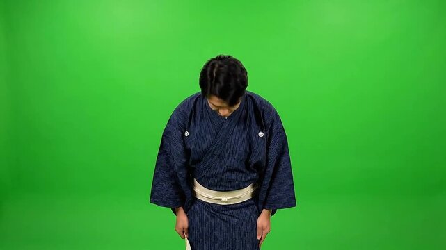 Japanese Man in Traditional Kimono Bowing on Isolated Green Screen Background in Studio with Natural Lighting and White Fan