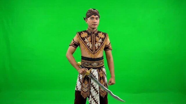 Man in Traditional Javanese Attire Holding Kris Dagger on Green Screen Background Ready for Cultural Performances and Historical