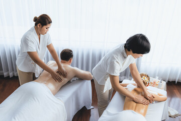 Caucasian couple customer enjoying relaxing anti-stress spa massage and pampering with beauty skin...
