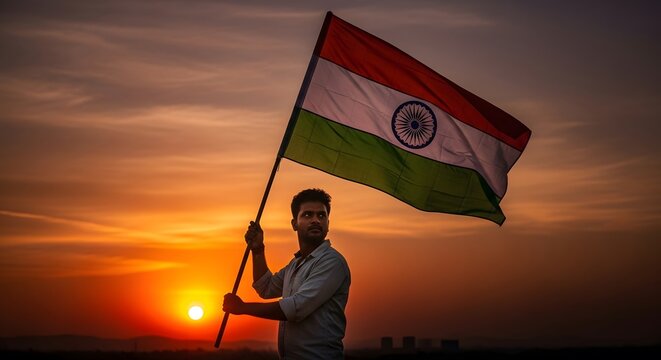 person holding the Indian flag at sunset