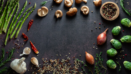 Groups of healthy foods for cooking dinner against a dark background.