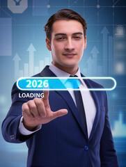 Businessman loading 2026 progress on futuristic touchscreen interface