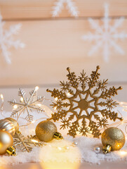 Golden snowflakes and christmas ornaments on white snow