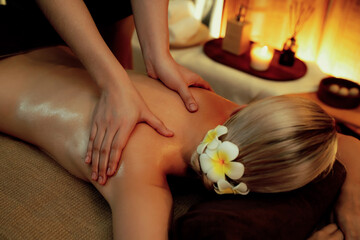 Closeup woman customer enjoying relaxing anti-stress spa massage and pampering with beauty skin...