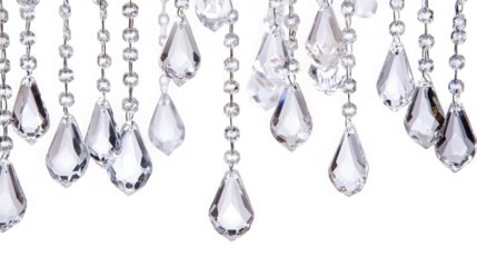 Close up of hanging crystal chandelier pendants on strings against a black background studio shot