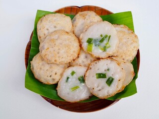 Thai coconut pudding is placed on a babana leaf on a plate. Delicious Thai dessert.