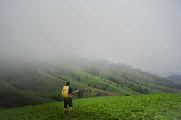 Fototapeta premium Asian man hiking with beautiful view