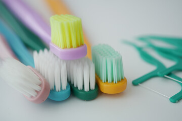Colorful toothbrushes and flossing tools arranged neatly
