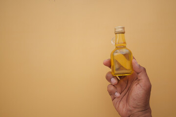 Small yellow bottle on a plain background