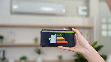 Home Energy Efficiency. A person checking energy efficiency on smartphone app.