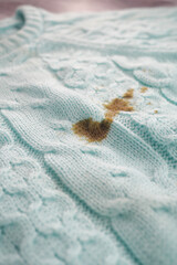 Stain on a light blue knitted sweater fabric