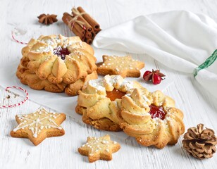 Festive cookies, spice, and decor on a white wooden surface