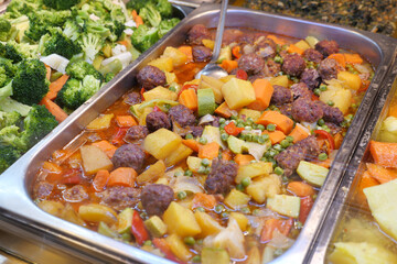 Healthy stew with vegetables and meatballs at a buffet
