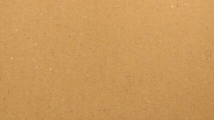 Background of brown kraft paper or cardboard texture. Abstract pattern of beige rough carton, old paper sheet.