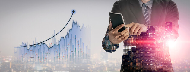 A business professional stands in an urban setting, using a smartphone while surrounded by digital...