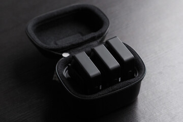 Small wireless microphones in case for recording audio.