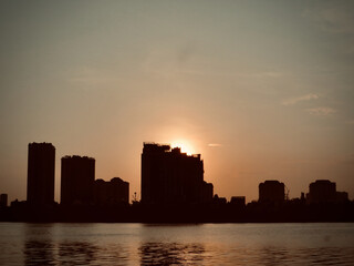 Golden Sunset Skyline over Tranquil Lake on West Lake in Hanoi, Vietnam