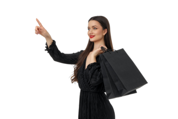 Joyful woman points with shopping bags at sale, isolated, PNG