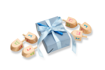 Gift box with blue ribbon and wooden dreidels, isolated, PNG