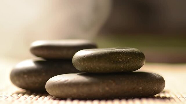 A tranquil stack of smooth zen stones for spa therapy and meditation, symbolizing balance and harmony in a peaceful wellness setting - Powered by Adobe